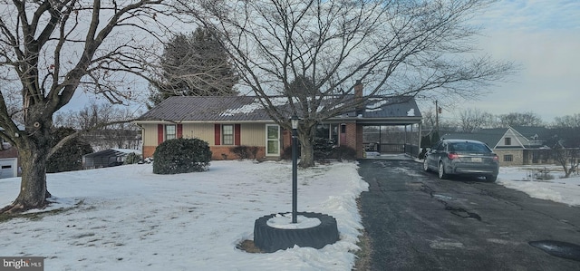 ranch-style house featuring a carport