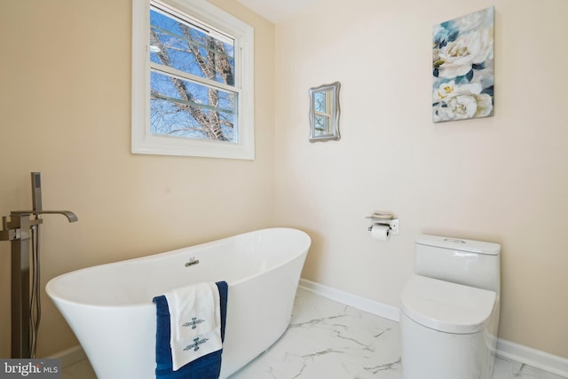 bathroom featuring toilet and a tub