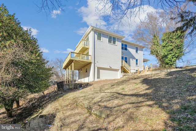 view of property exterior with a balcony, a garage, and a yard