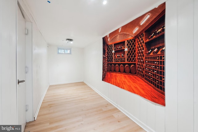 wine room with hardwood / wood-style floors