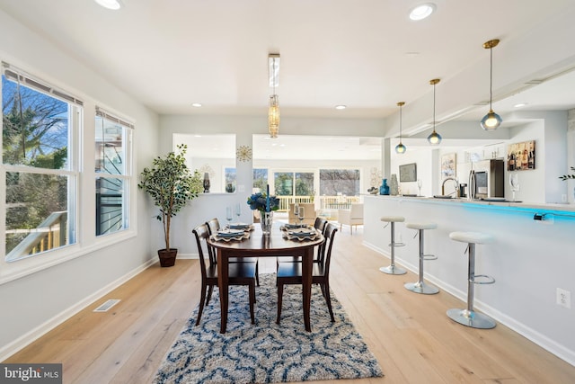 dining area featuring light wood-type flooring