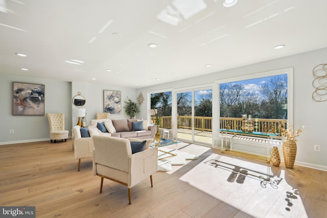 living room with a wealth of natural light and light wood-type flooring