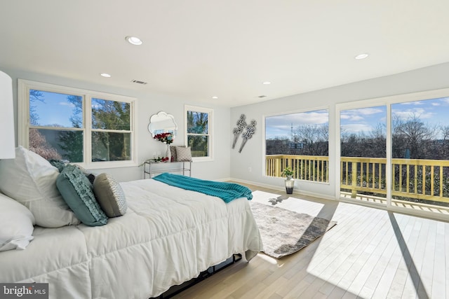 bedroom with light hardwood / wood-style flooring and access to outside