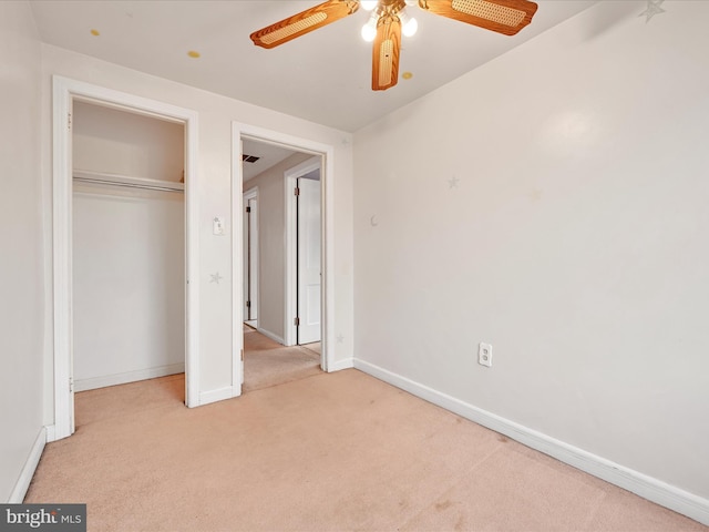 unfurnished bedroom featuring a closet, light colored carpet, and ceiling fan