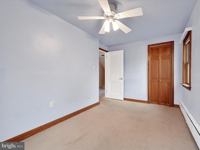 unfurnished bedroom with light carpet, a baseboard radiator, and ceiling fan