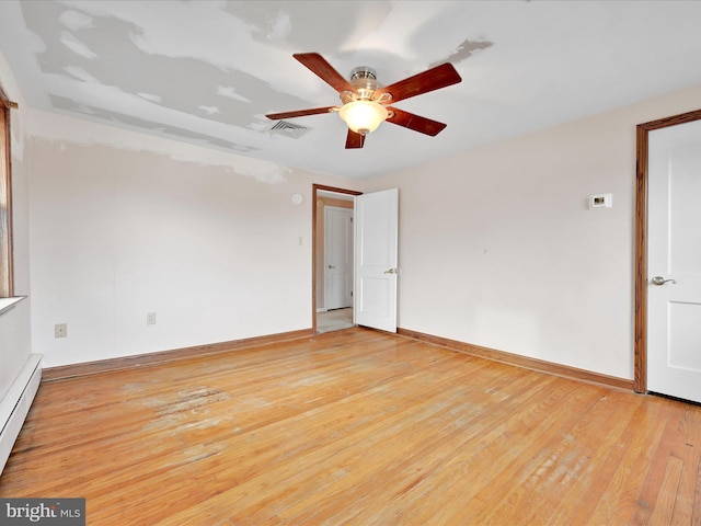 empty room with ceiling fan, light wood-type flooring, and a baseboard radiator