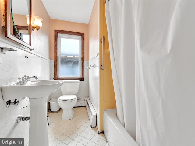 bathroom featuring shower / tub combo with curtain, a baseboard radiator, and toilet