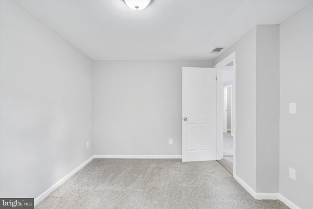 unfurnished room featuring light carpet