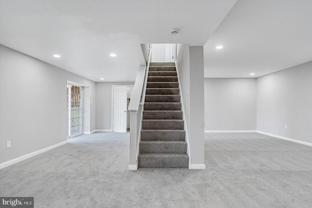 stairs featuring carpet flooring