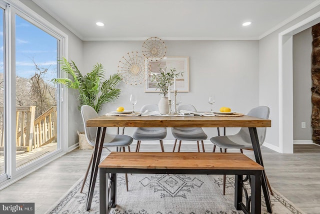 dining area featuring crown molding and hardwood / wood-style floors