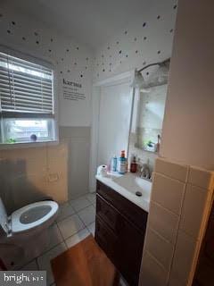 bathroom with tile patterned floors, vanity, and toilet