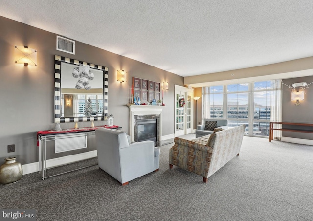 living room with a premium fireplace, carpet, and a textured ceiling