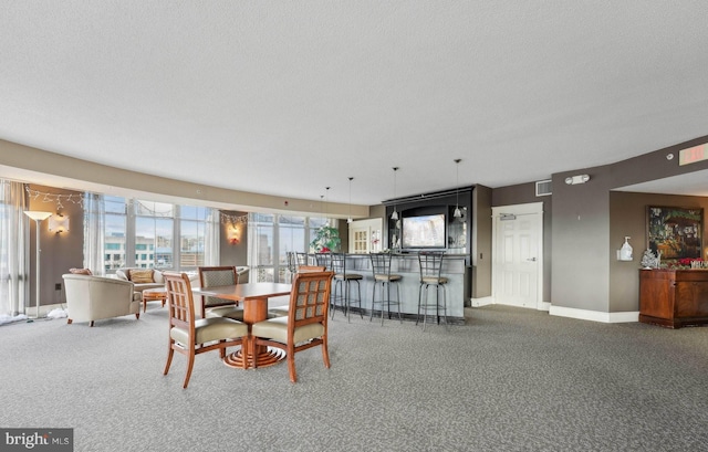 carpeted dining space featuring bar