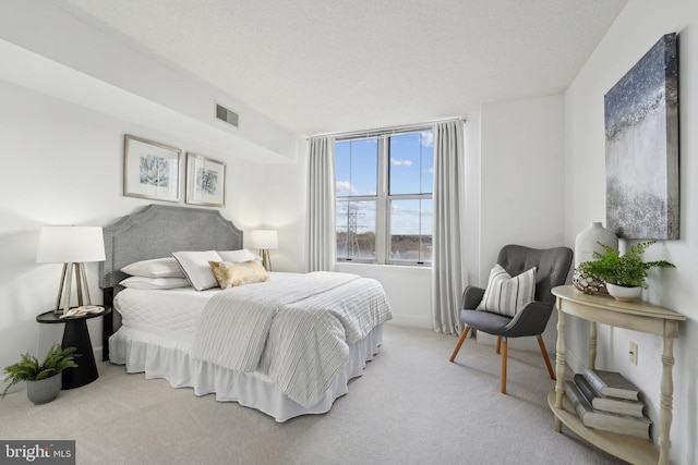 carpeted bedroom featuring a textured ceiling