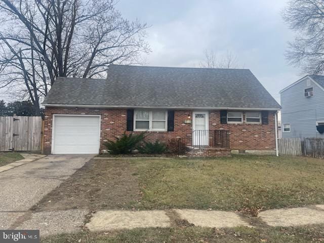 view of front of home with a garage and a front lawn