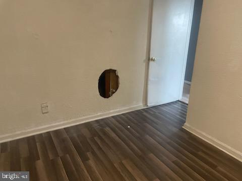 spare room featuring dark hardwood / wood-style floors