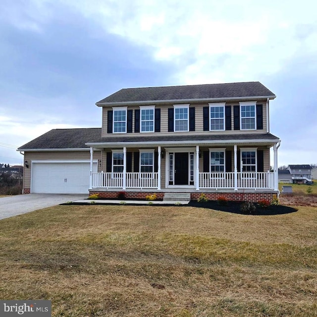 colonial home featuring covered porch, a garage, and a front lawn