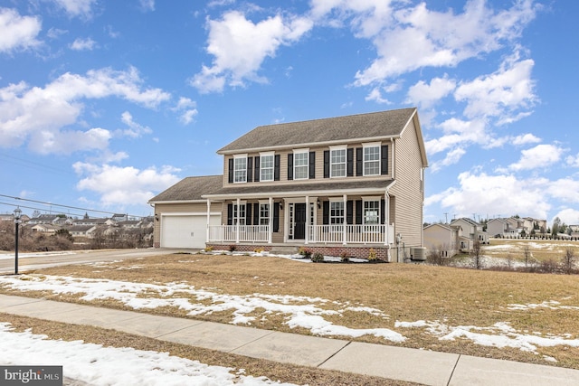 colonial home featuring covered porch, a garage, and central air condition unit