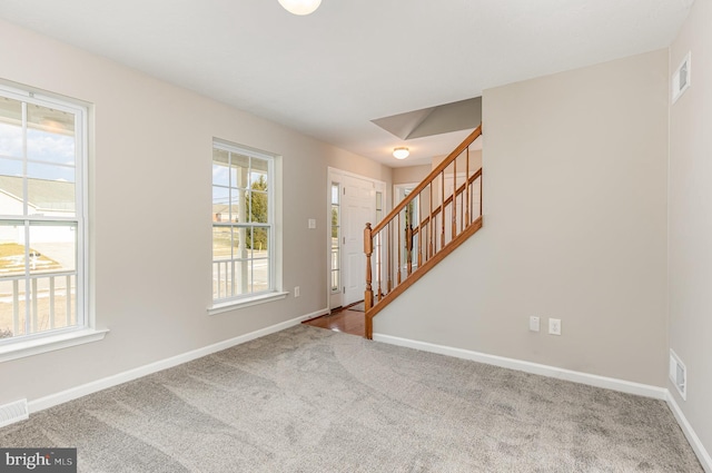 view of carpeted foyer