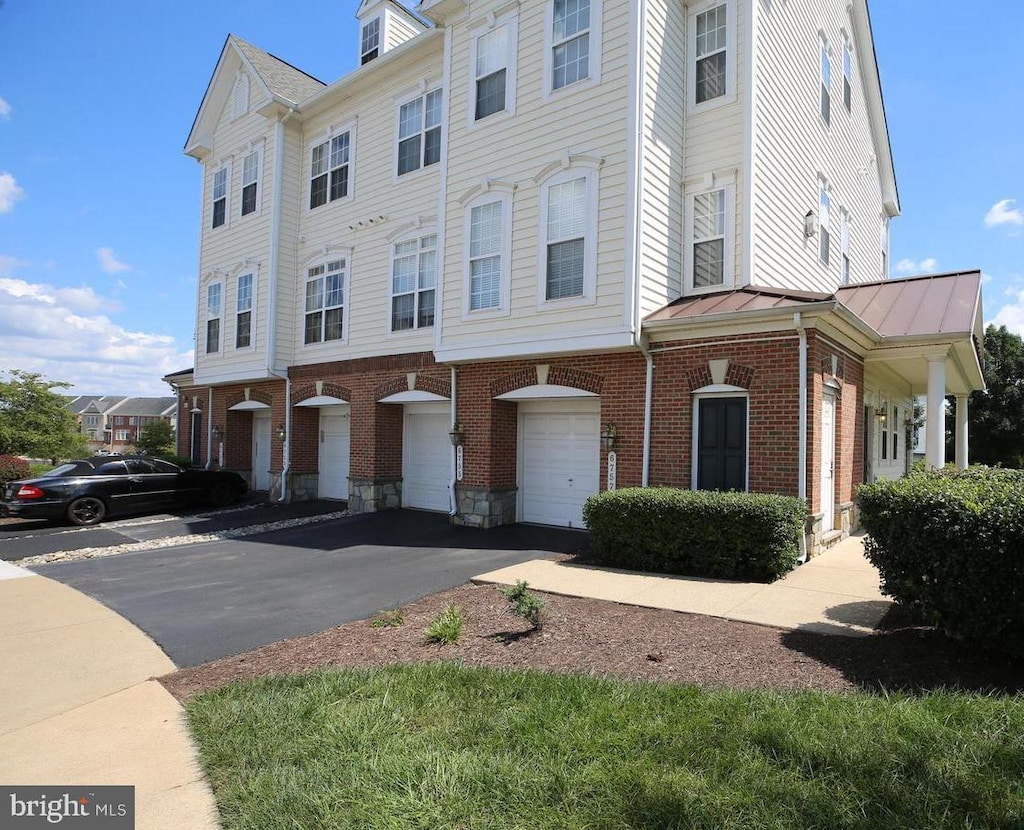 multi unit property featuring a garage