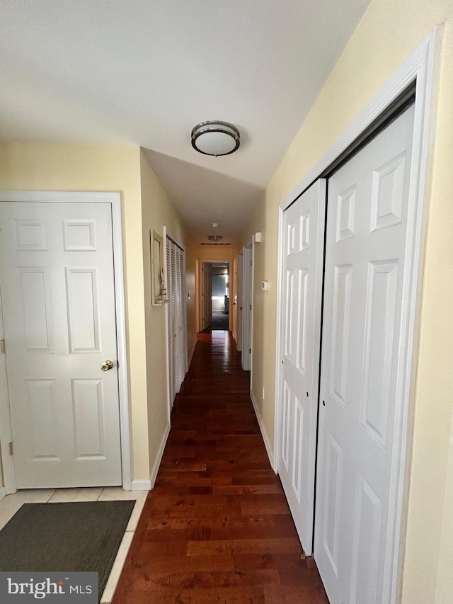 corridor featuring dark hardwood / wood-style floors