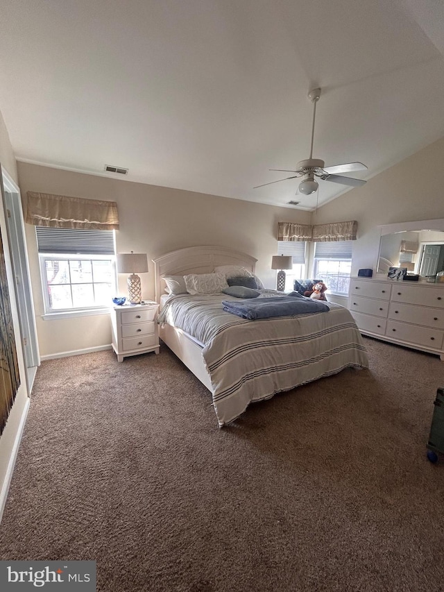 unfurnished bedroom with dark carpet, ceiling fan, and lofted ceiling