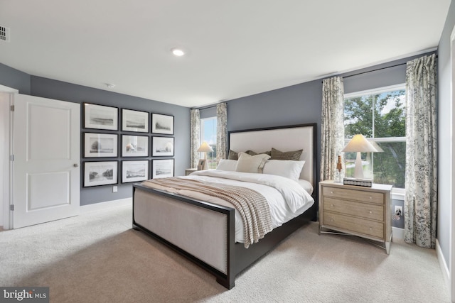 bedroom with light colored carpet