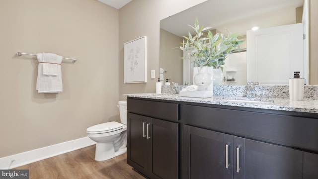 bathroom featuring hardwood / wood-style flooring, vanity, and toilet