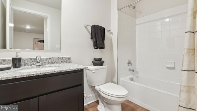 full bathroom with vanity, hardwood / wood-style flooring, toilet, and shower / bath combo with shower curtain