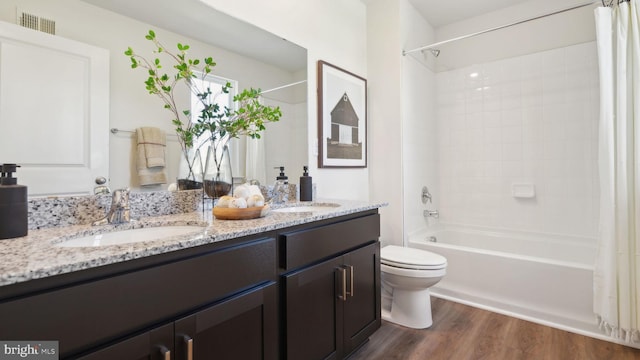 full bathroom featuring shower / bath combo with shower curtain, vanity, wood-type flooring, and toilet