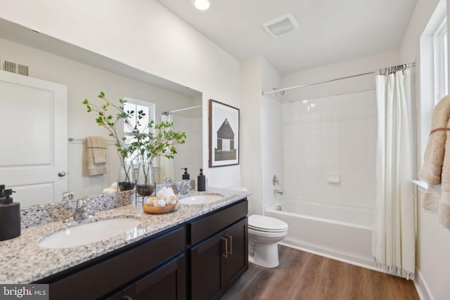 full bathroom with wood-type flooring, vanity, toilet, and shower / bath combo