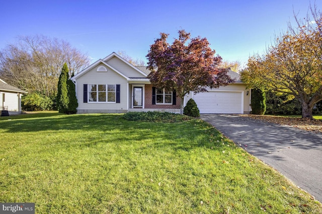 view of front of house featuring a front yard and a garage