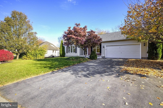 view of front of house with a garage and a front lawn