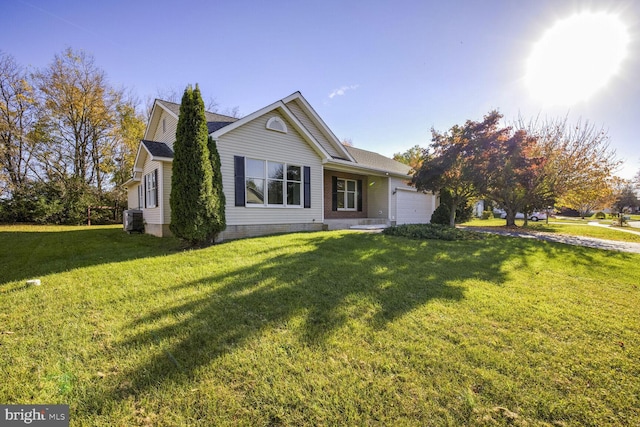 view of front facade featuring a front yard, central AC, and a garage