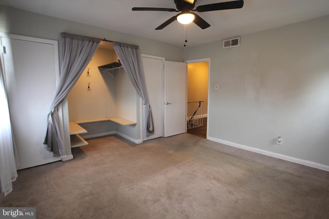 unfurnished bedroom featuring carpet and ceiling fan