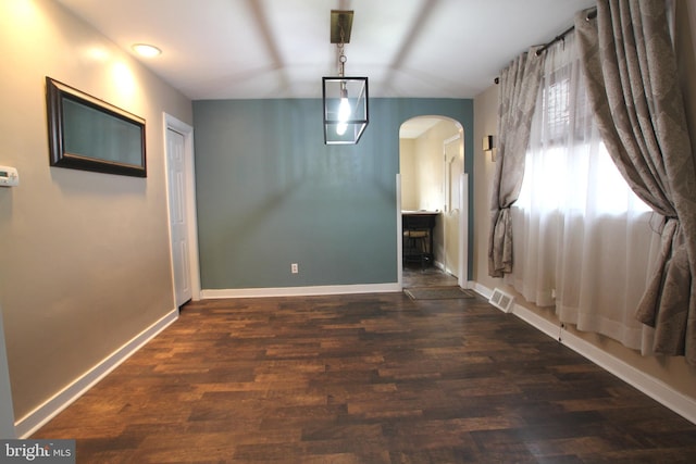 unfurnished dining area featuring dark wood-type flooring