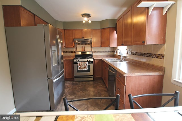 kitchen featuring sink, appliances with stainless steel finishes, and tasteful backsplash