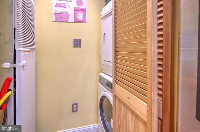 clothes washing area featuring stacked washer and dryer