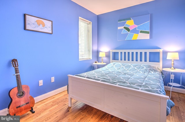 bedroom with wood-type flooring