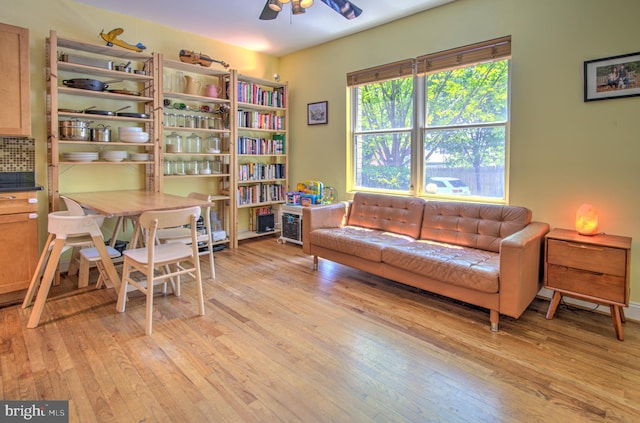 living area with ceiling fan and light hardwood / wood-style floors