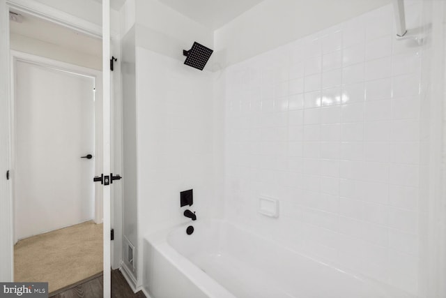 bathroom featuring shower / tub combination and hardwood / wood-style floors