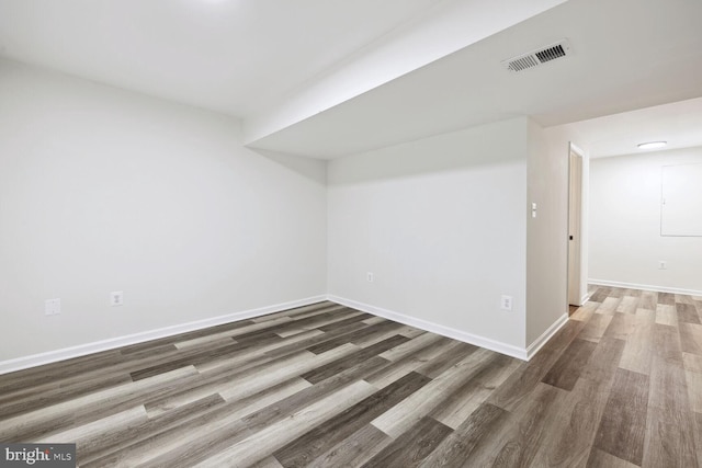 empty room with dark hardwood / wood-style flooring