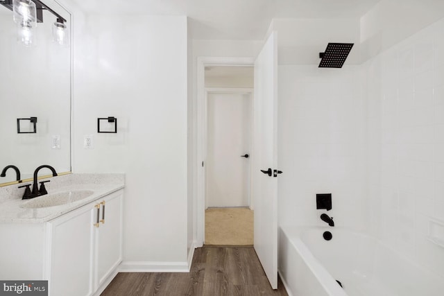 bathroom with shower / bath combination, vanity, and wood-type flooring