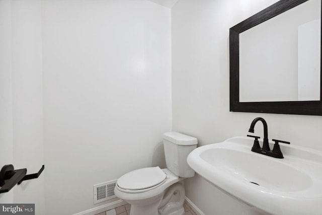 bathroom featuring tile patterned floors, sink, and toilet