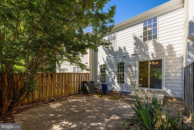 rear view of property featuring central AC and a patio