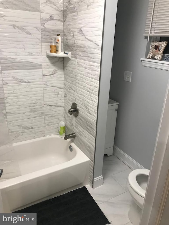 bathroom with shower / bathing tub combination and toilet