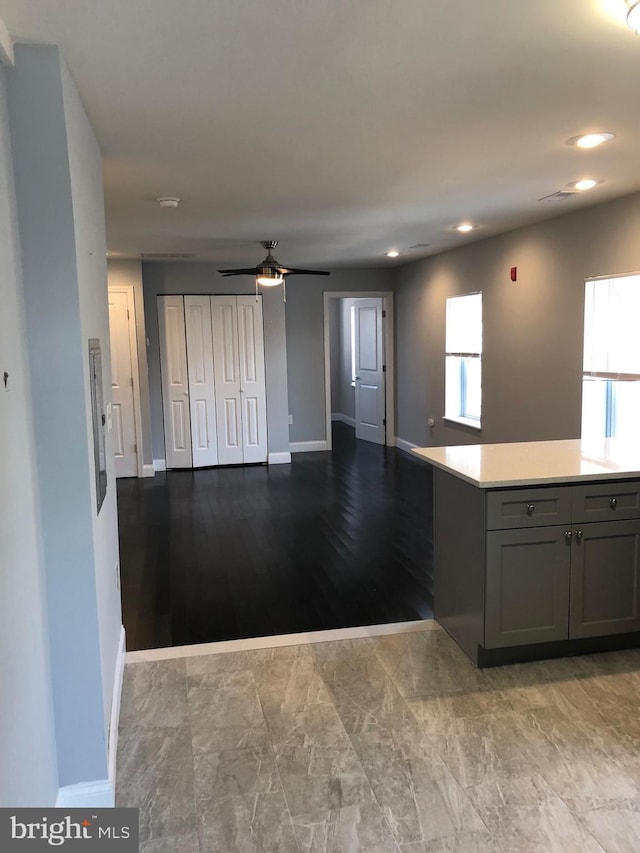 kitchen with ceiling fan, plenty of natural light, and gray cabinetry