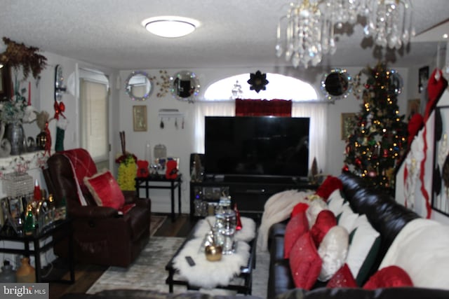 living room with a chandelier and a textured ceiling