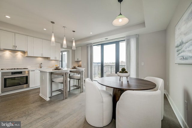 dining space featuring sink and light wood-type flooring