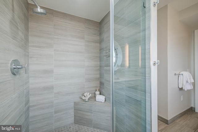 bathroom with a shower with door